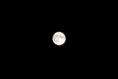 Low angle view of moon against dark sky