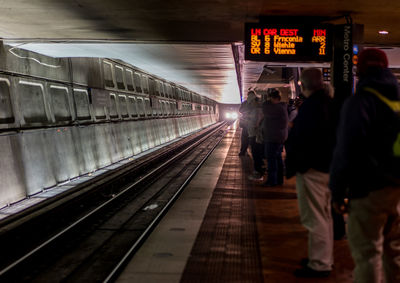 Commuters waiting at subway station platform