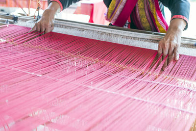 Close-up of female weaving cotton