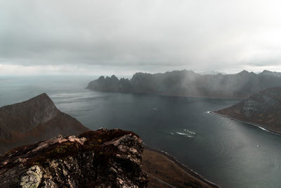 Scenic view of sea and mountains against sky