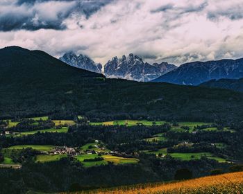 Scenic view of field and mountains against sky