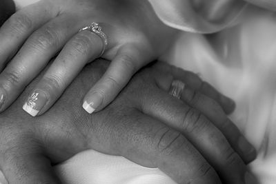 Cropped image of couple holding hands