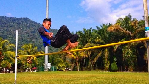 Man playing soccer on field against sky