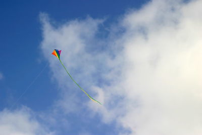 Low angle view of kite flying against blue sky