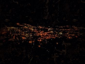 Aerial view of illuminated city at night