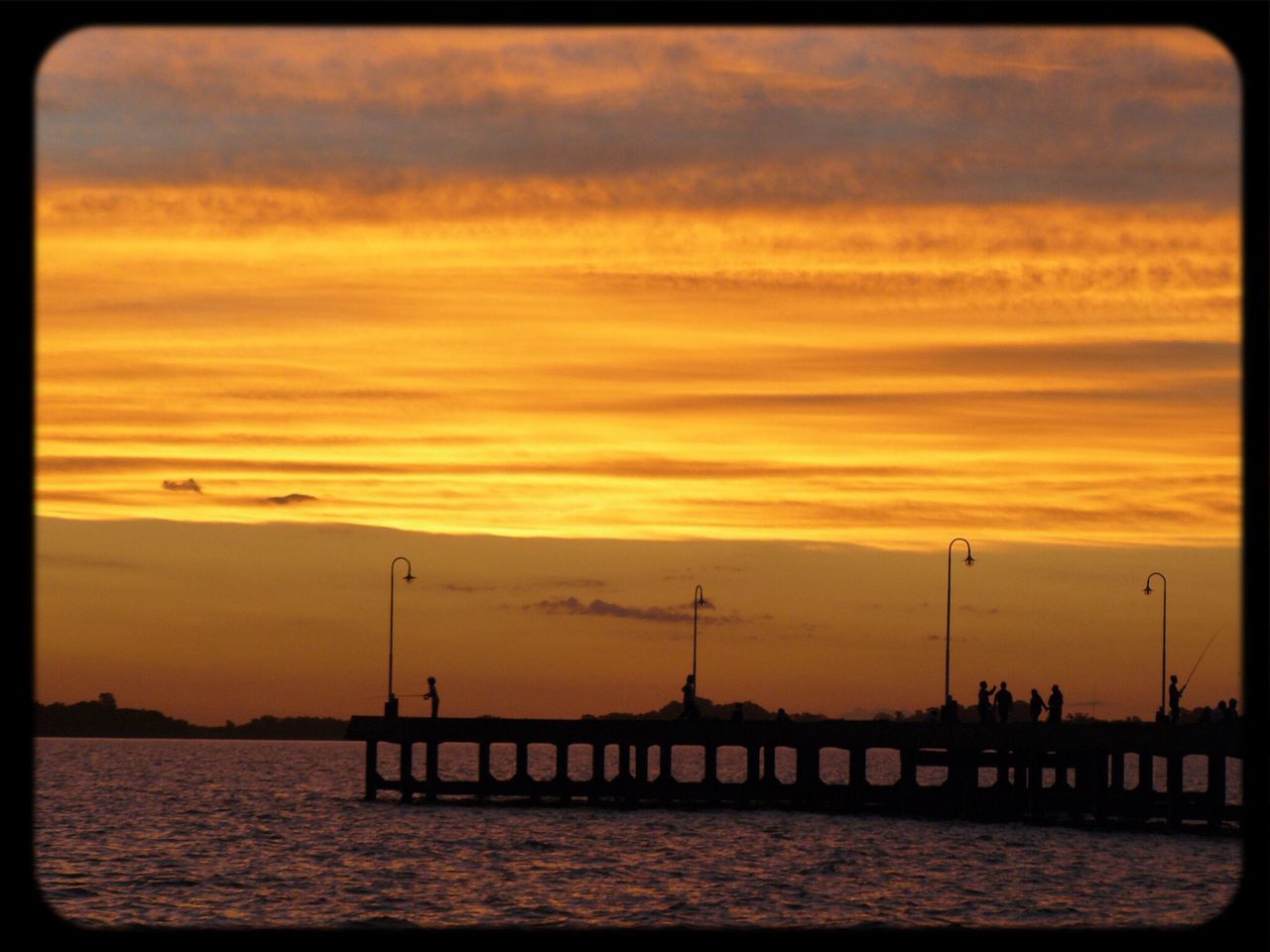 sunset, water, sky, sea, silhouette, orange color, built structure, scenics, beauty in nature, waterfront, cloud - sky, architecture, tranquil scene, tranquility, nature, pier, connection, dusk, dramatic sky, idyllic