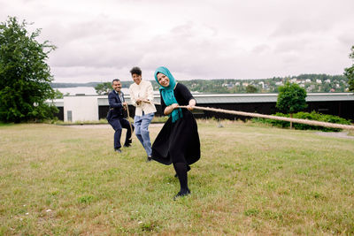 Full length of women standing on field against sky