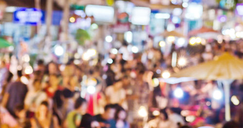 Defocused image of crowd at amusement park