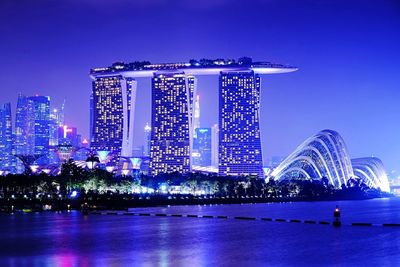 Illuminated marina bay sands against sky at night