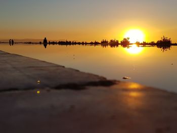 Scenic view of beach against sky during sunset