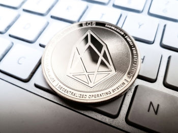 High angle view of coin with ethereum text on computer keyboard