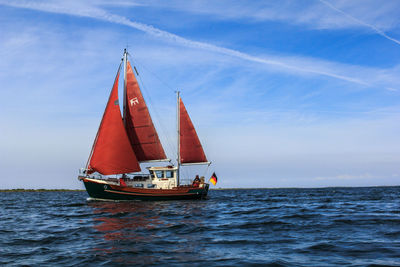 Sailboat sailing in sea against sky