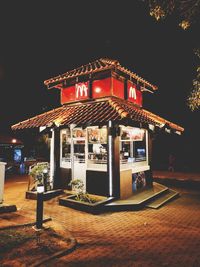 Illuminated building against sky at night