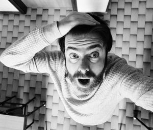 Portrait of man with arms raised