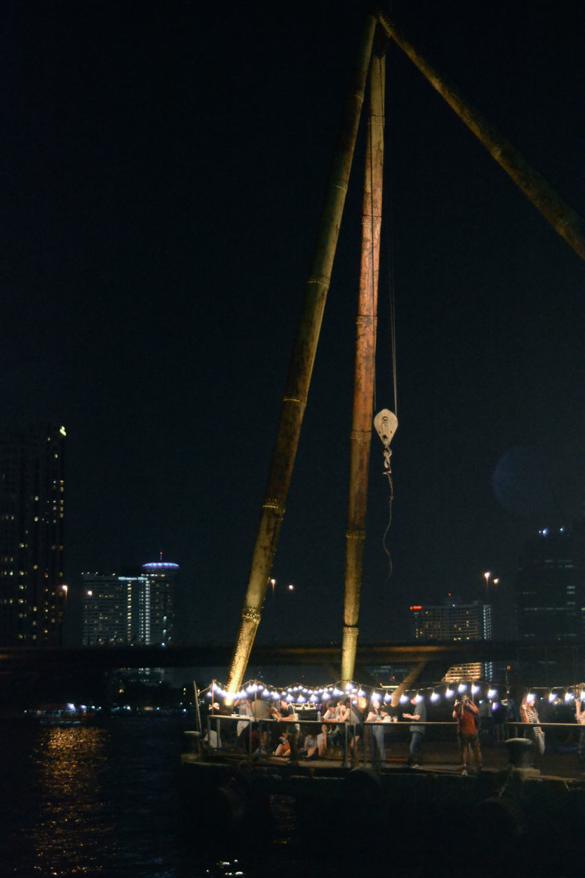 night, illuminated, transportation, nautical vessel, built structure, architecture, water, river, city, bridge - man made structure, mode of transport, engineering, boat, waterfront, building exterior, travel, clear sky, connection, harbor, copy space