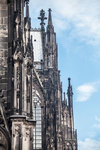 Low angle view of cologne cathedral against cloudy sky