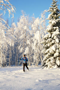 Full length of woman walking on snowcapped mountain