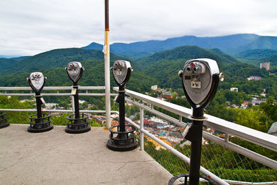 Close-up of security camera against sky