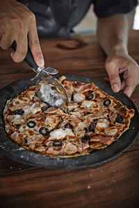 Midsection of man holding pizza