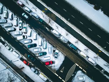 High angle view of cars parked on snow covered parking lot