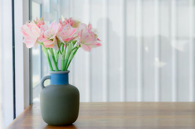 Close-up of pink flower vase on table at home