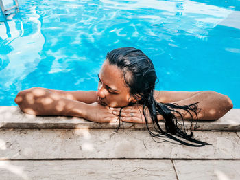 Young woman in bikini in swimming pool. summer, lifestyle.