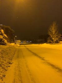 Road in city at night during winter