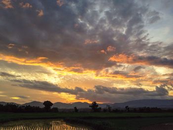 Scenic view of landscape against cloudy sky