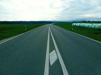 Empty country road against sky