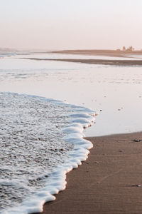 Scenic view of beach against clear sky