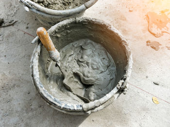 Cement mortar and trowel in mixing bucket, construction equipment important