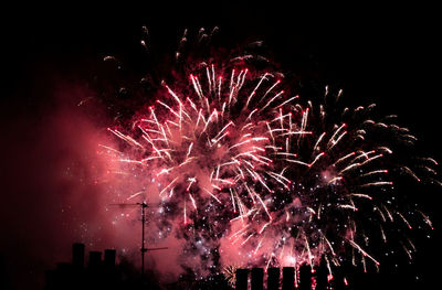 Low angle view of firework display at night