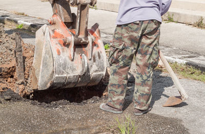 Low section of man standing at construction site