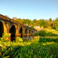 Close-up of arch bridge against clear sky