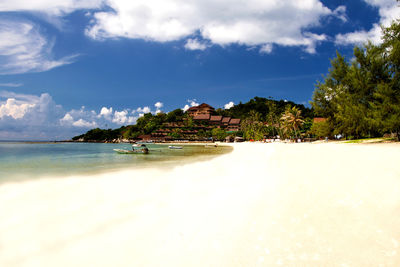 Scenic view of beach by sea against sky