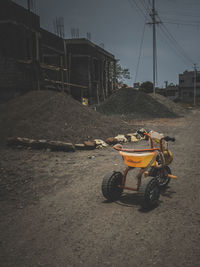 Motorcycle on street in city against sky