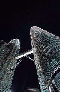 Low angle view of modern buildings against sky at night