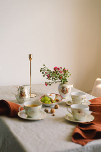 Vintage table setting with linen napkins and floral decorations. close up.