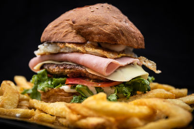 Close-up of burger against black background