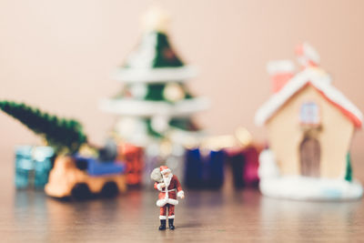 Santa claus and christmas gifts on table