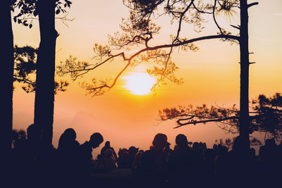 Silhouette people against sky during sunset