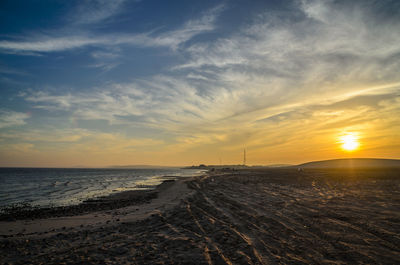 Scenic view of beach against sky during sunset