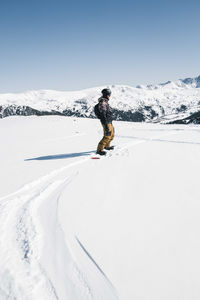 Man snowboarding off piste slope