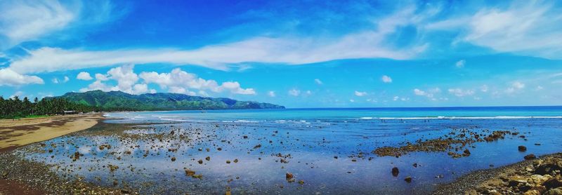 Scenic view of sea against blue sky