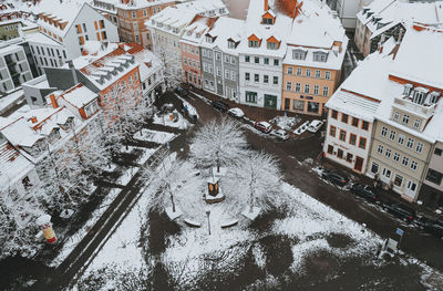 High angle view of canal amidst buildings in city during winter