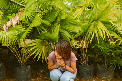 Woman sitting on plant