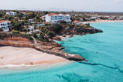 Aerial view of sea and buildings against sky