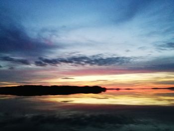 Scenic view of dramatic sky over sea during sunset