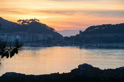 Scenic view of lake against orange sky