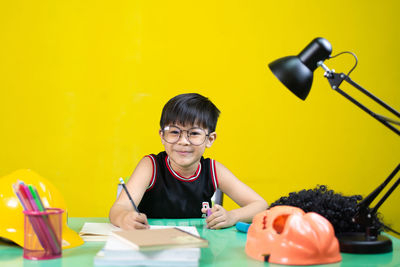 Portrait of smiling girl on table